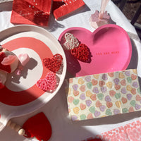 Pink heart shaped paper plates with the words you are here - perfect for a valentines day party or a bachelorette party