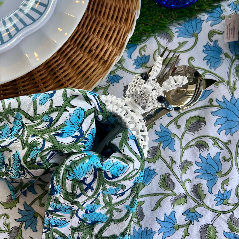 White wicker bunny Easter napkin ring on a blue easter tablescape - its perfect for a preppy, classic Easter look.