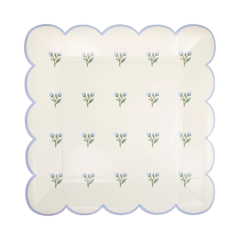 Close-up of floral paper plates with delicate pastel blooms and scalloped detailing, perfect for a spring gathering.